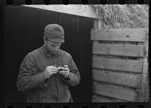 Untitled photo, possibly related to: Rex Inman, farmer, near Estherville, Iowa, rolling a cigarette. Very few farmers smoke "tailor mades"