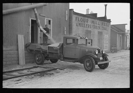 Loading corn onto truck from elevator, Spencer, Iowa