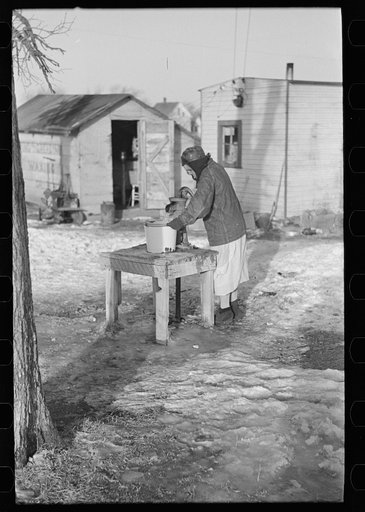 Untitled photo, possibly related to: Woman pumping water for laundry, "Shantytown," Spencer, Iowa