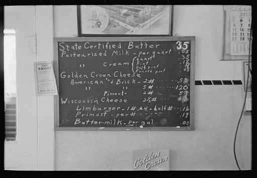 Sign showing scale of prices (retail) at farmer cooperative creamery, Ruthven, Iowa. Note the low prices
