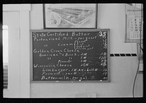Untitled photo, possibly related to: Sign showing scale of prices (retail) at farmer cooperative creamery, Ruthven, Iowa. Note the low prices