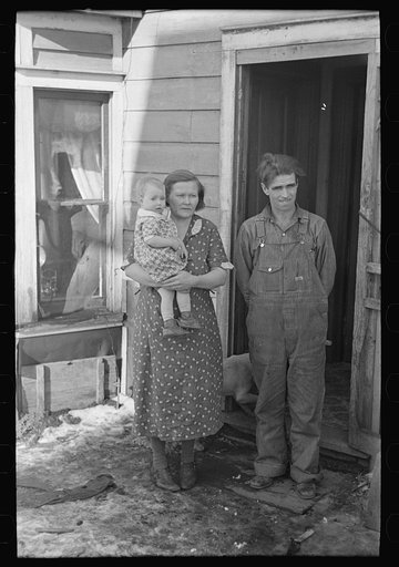 Mr. Rauhauser, wife and one of his seven children, Ruthven, Iowa. He works as a farm hand. At present he is out of work. He has made application for direct relief