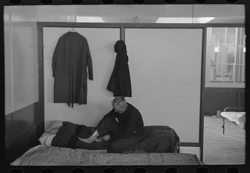 Man examining ankle, homeless men's bureau, Sioux City, Iowa