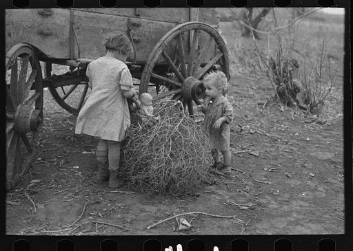 Untitled photo, possibly related to: Children of Earl Pauley, playing with dolls in tumbleweed, near Smithland, Iowa
