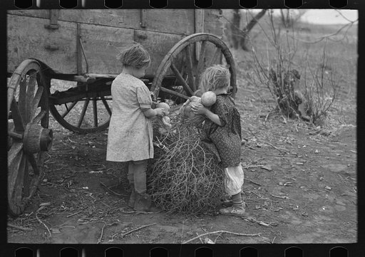 Children of Earl Pauley, playing with dolls in tumbleweed, near Smithland, Iowa