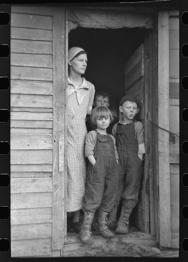 Mrs. Frank Moody with two of her seven children on their eighty acre farm in Miller Township, Woodbury County, Iowa