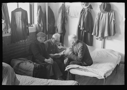 Untitled photo, possibly related to: Man reading to fellow inmates, homeless men's bureau, Sioux City, Iowa