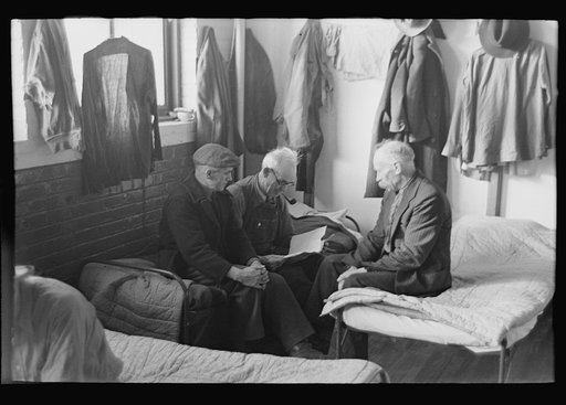 Untitled photo, possibly related to: Man reading to fellow inmates, homeless men's bureau, Sioux City, Iowa