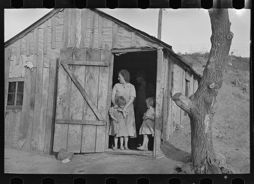 Mrs. Earl Pauley and some of her children in doorway of farm home near Smithland, Iowa. They are tenant farmers