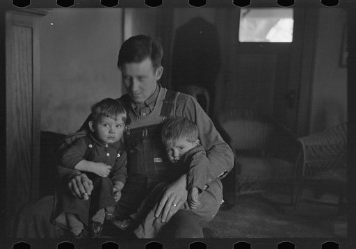 Untitled photo, possibly related to: J. Donnell Champion and his two children who received a start from resettlement two years ago. He has applied for a resettlement grant for feed to get his livestock through the winter