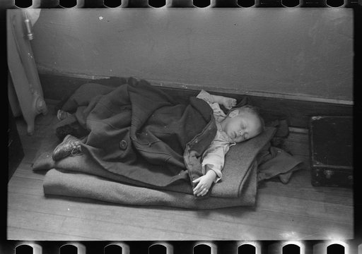 Young flood refugee asleep in schoolhouse, Sikeston, Missouri