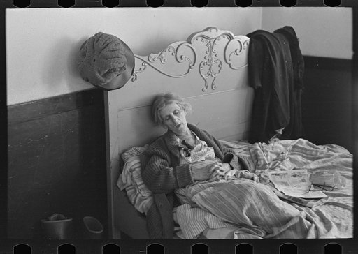 Exhausted flood refugee resting, Sikeston, Missouri