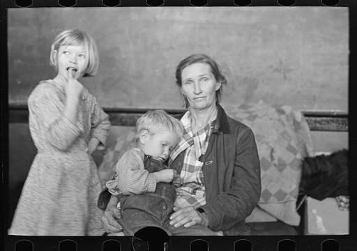 Mother and two children, flood refugees in the schoolhouse at East Prairie, Missouri