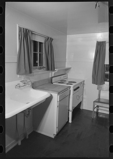 Untitled photo, possibly related to: Sink, refrigerator and stove in the kitchen of the model house at Greendale, Wisconsin