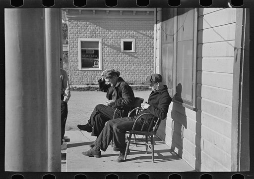 Lumberjacks sitting in front of the Durman Hotel, Little Fork, Minnesota