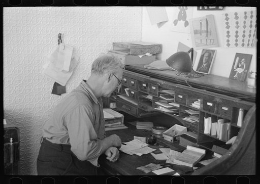 General storekeeper looking over bill, Ericsburg, Minnesota