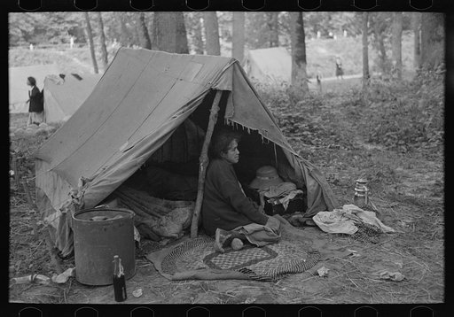 Woman in front of tent, blueberry camp, near Little Fork, Minnesota