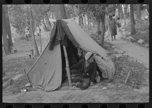 Indian boy in front of tent near Little Fork, Minnesota