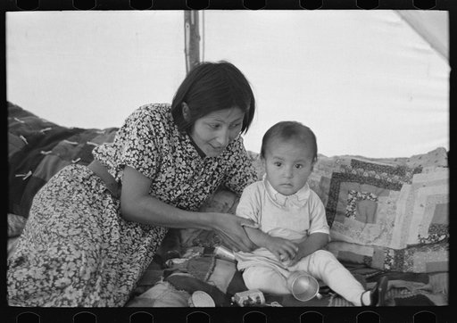 Indian mother and baby in their temporary home, near Little Fork, Minnesota
