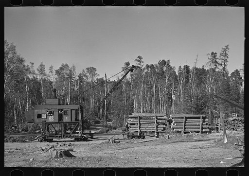 Loading device moving railroad cars full of timber at camp near Effie, Minnesota
