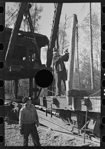 Untitled photo, possibly related to: Loading device moving railroad cars full of timber at camp near Effie, Minnesota