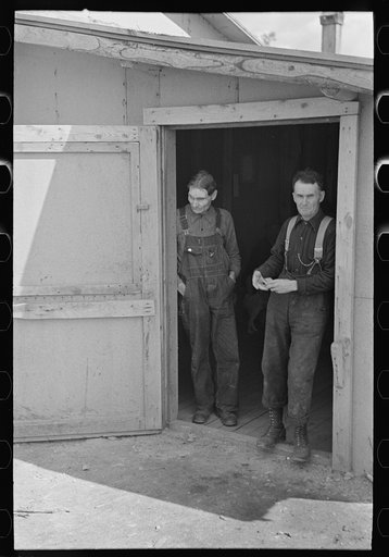 Untitled photo, possibly related to: Lumberjacks in doorway of bunkhouse, near Effie, Minnesota
