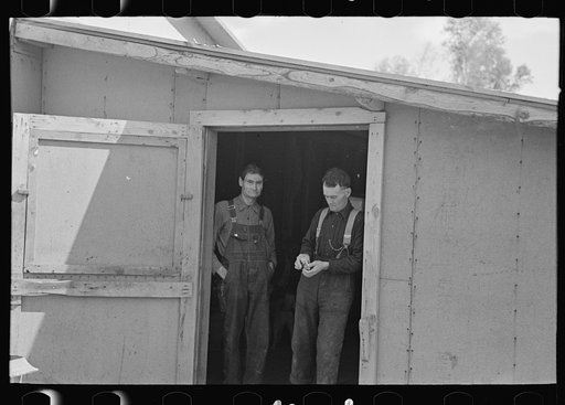 Lumberjacks in doorway of bunkhouse, near Effie, Minnesota