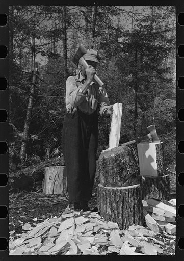 Untitled photo, possibly related to: Using the broadaxe to make wedges, at camp near Effie, Minnesota