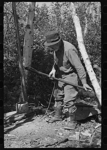 Untitled photo, possibly related to: William Besson removing the iron pipe drill from casing near Winton, Minnesota