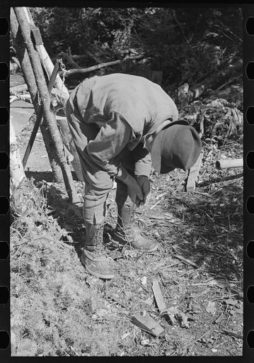 Untitled photo, possibly related to: William Besson working on his drilling rig on location, near Winton, Minnesota