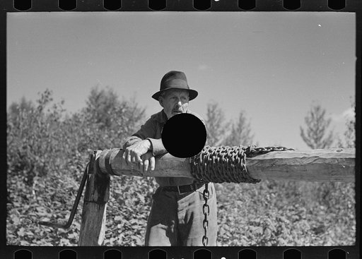 Untitled photo, possibly related to: William Besson, mining prospector, near Winton, Minnesota. The windlass is homemade