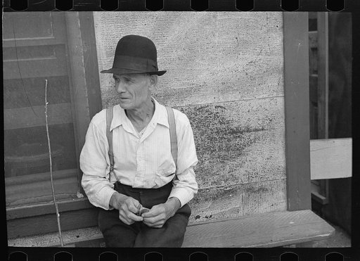 Man sitting on bench, Craigville, Minnesota