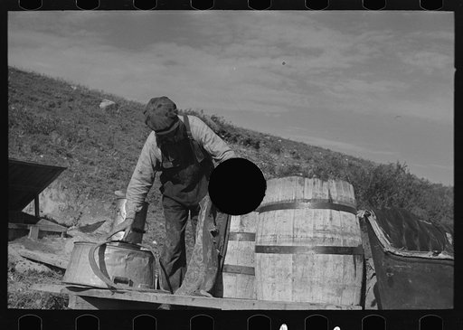 Untitled photo, possibly related to: Filling barrels with spring water to be used on farm of Herman Gerling, Wheelock, North Dakota