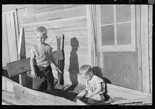 Sons of Floyd Peaches playing around their home near Williston, North Dakota