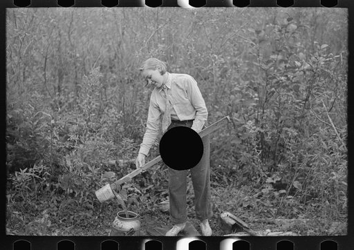 Untitled photo, possibly related to: Filling can with water from shallow well on farm near Northome, Minnesota