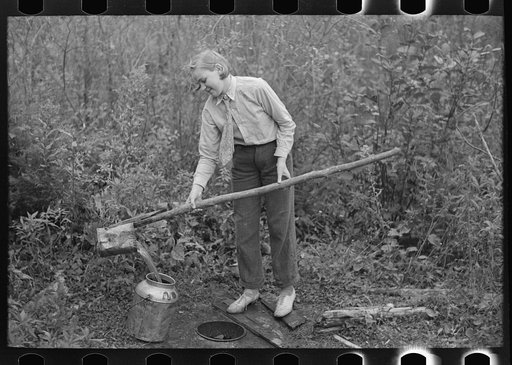 Untitled photo, possibly related to: Filling can with water from shallow well on farm near Northome, Minnesota