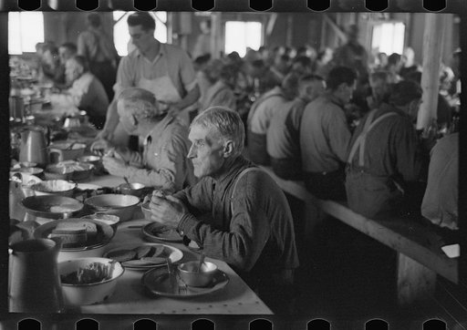 Lumberjacks eating dinner at camp near Effie, Minnesota