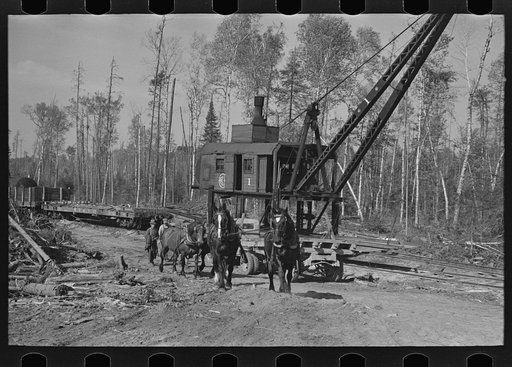 Untitled photo, possibly related to: Caterpillar drawing logs through the woods at camp near Effie, Minnesota