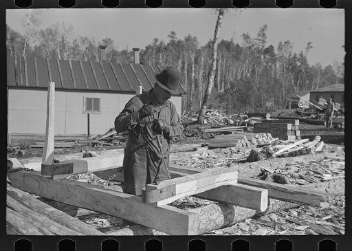 Drilling hole in construction of sleds for hauling timber at camp near Effie, Minnesota