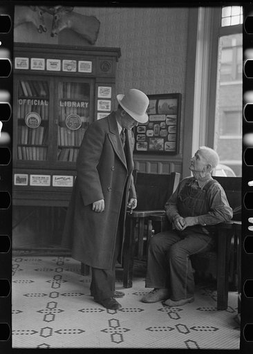 Two men talking in the Great Northern Hotel, Williston, North Dakota