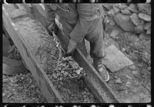 Untitled photo, possibly related to: Gold miner working in sluice box, Two Bit Creek, South Dakota