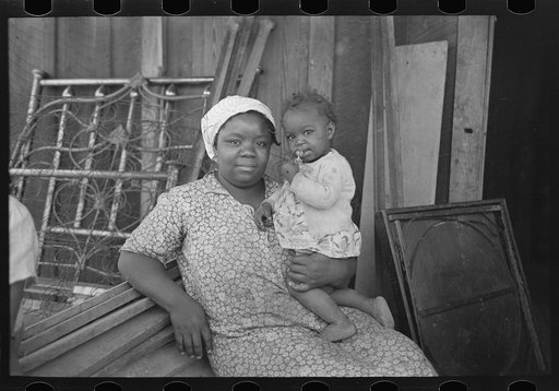 Mother and child, FSA (Farm Security Administration) clients, former sharecroppers, just before moving to Southeast Missouri Farms