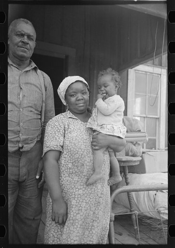 Untitled photo, possibly related to: Mother and child, FSA (Farm Security Administration) clients, former sharecroppers, just before moving to Southeast Missouri Farms