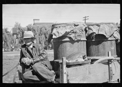 Farmer sitting in wagon at liquid feed loading station at Owensboro, Kentucky
