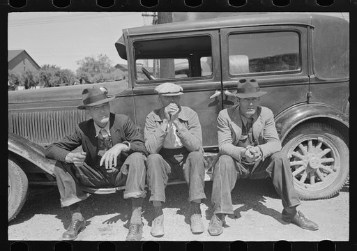 Untitled photo, possibly related to: Farmers sitting on running board of car at liquid feed loading station, Owensboro, Kentucky