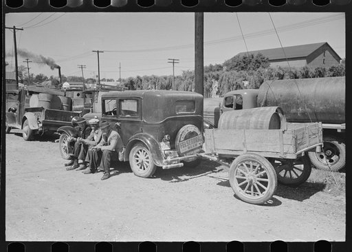 Untitled photo, possibly related to: Farmers sitting on running board of car at liquid feed loading station, Owensboro, Kentucky