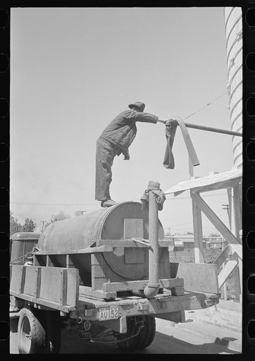 Untitled photo, possibly related to: Loading liquid feed onto wagon, Owensboro, Kentucky