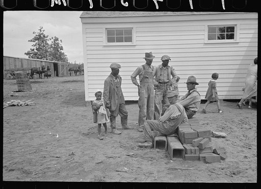 Members of the La Forge Farms Cooperative Society in front of cooperative store
