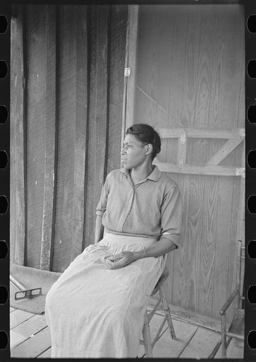 Wife of sharecropper on front porch of shack home, Southeast Missouri Farms