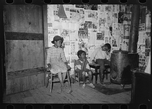 Southeast Missouri Farms. Children sitting in living room of shack home